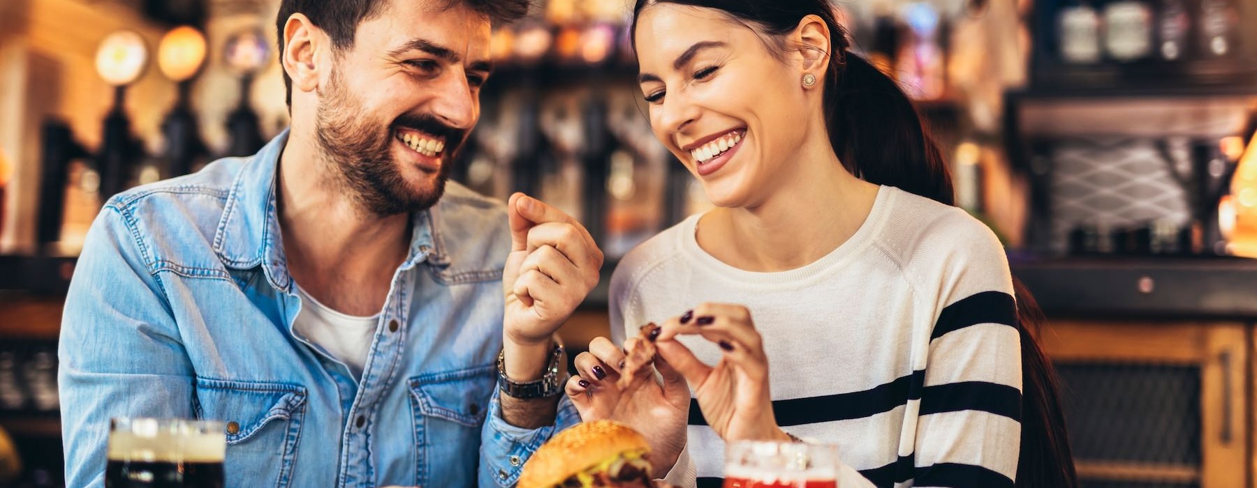 a man and woman eating at a restaurant
