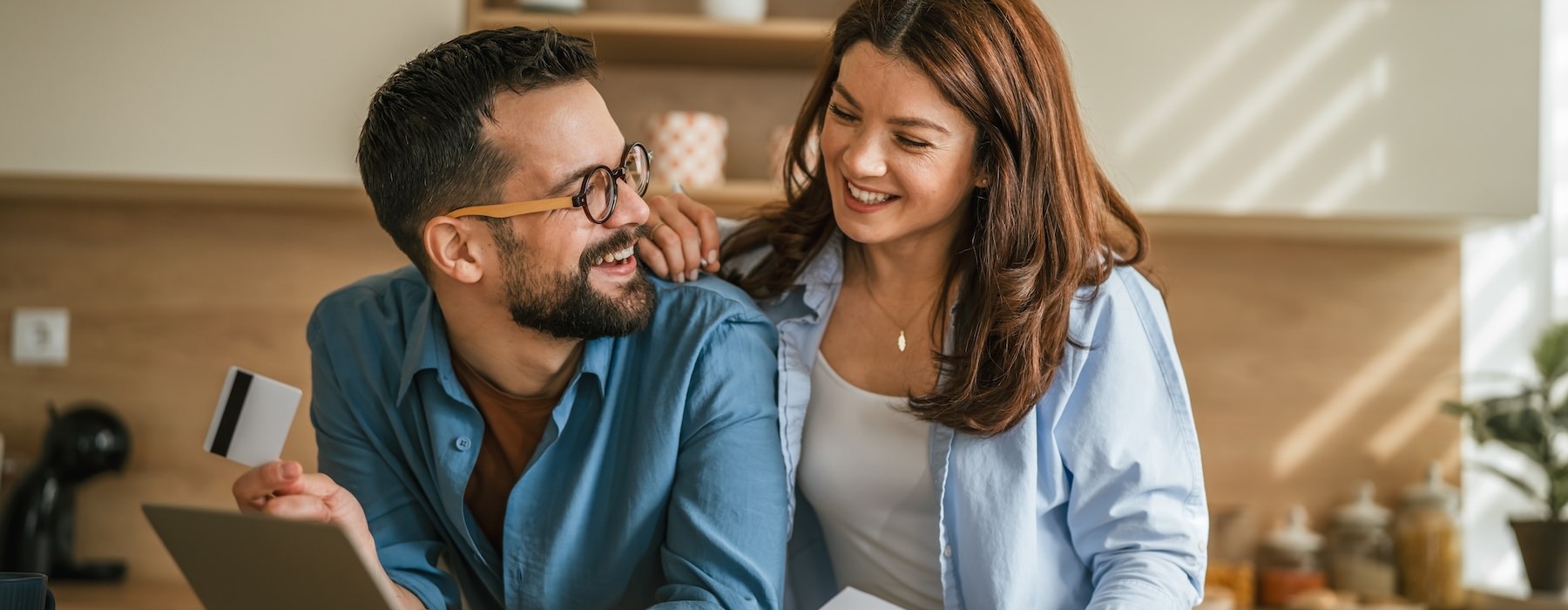 a man and a woman looking at a laptop